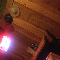 Two Bit Saloon - Hats on a rough wood wall( such interior decorating skill)