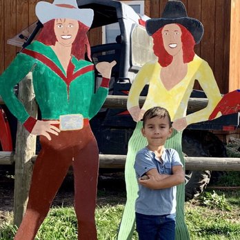 Moreno Valley Cowboy Evening - a young boy standing in front of a painted cowgirl - American Near Me - Red River, New Mexico Moreno Valley Cowboy Evening - a young boy standing in front of a painted cowgirl - American Near Me - Red River, New Mexico