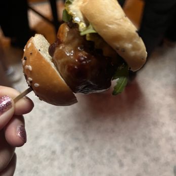 Track & Field Bar - a person holding a hot dog on a stick - Dance Clubs Near Me - Toronto, Ontario Track & Field Bar - a person holding a hot dog on a stick - Dance Clubs Near Me - Toronto, Ontario