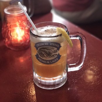 Icehouse - a glass of beer with a straw and a lemon wedge - Tex-Mex Near Me - Montreal, Quebec