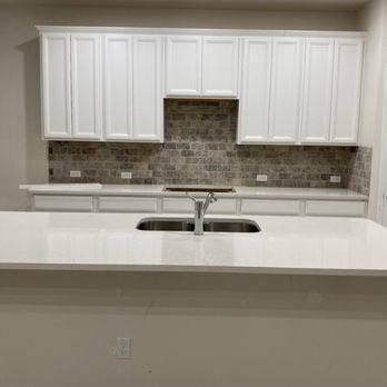 Rhino Renovations - a kitchen with white cabinets and white countertops - Flooring Near Me Rhino Renovations - a kitchen with white cabinets and white countertops - Flooring Near Me
