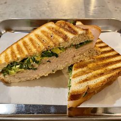 Brothers & Sisters Co Coffeehouse + Cafe - Daniel's panini on gluten free bread (turkey, avocado, arugula, and honey mustard, without the tomato) / Apr. 2024