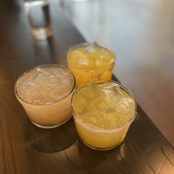 Luna - GRAND RAPIDS - three glasses filled with drinks on a wooden table - Mexican Near Me - Grand Rapids, Michigan Luna - GRAND RAPIDS - three glasses filled with drinks on a wooden table - Mexican Near Me - Grand Rapids, Michigan