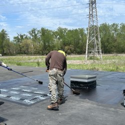 Mitchell roofing and exteriors - Flat Roof repair being done with Rubberized Coating.