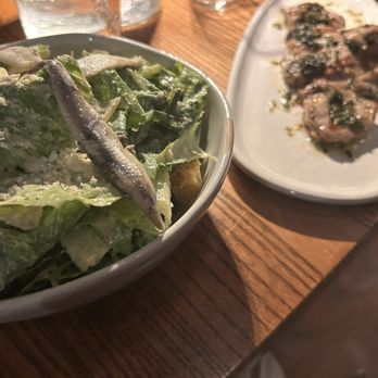 District Kitchen & Bar - Caesar salad with white anchovies. Lamp pops with mint - New American Near Me - Pittsfield, Massachusetts
