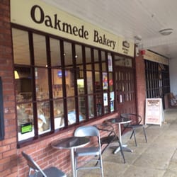 Oakmede Bakery - A couple of tables and chairs under cover outside the front of the bakery