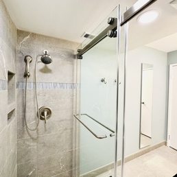 Walk in shower with grey tile and glass accent tile. Walk in shower with grey tile and glass accent tile.