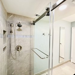 Tile Center - Walk in shower with grey tile and glass accent tile.