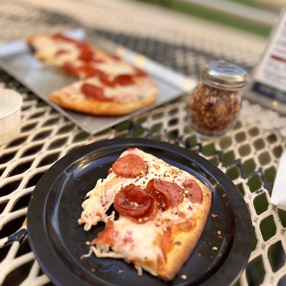 Mammoth Brewing - Slice of stacked pepperoni flat bread pizza. - Breweries Near Me - Mammoth Lakes, California