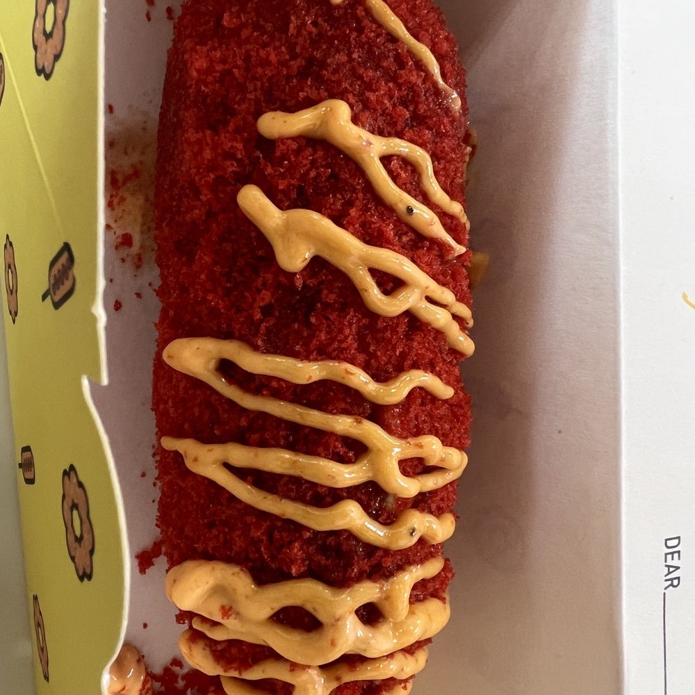Mochinut - Whole Mozzarella hot dog with hot Cheetos topping and spicy mayo drizzle - Donuts Near Me - Plano, Texas