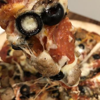 Papa Murphy's - a slice of pizza being lifted by a spatula - Pizza Near Me - Placerville, California