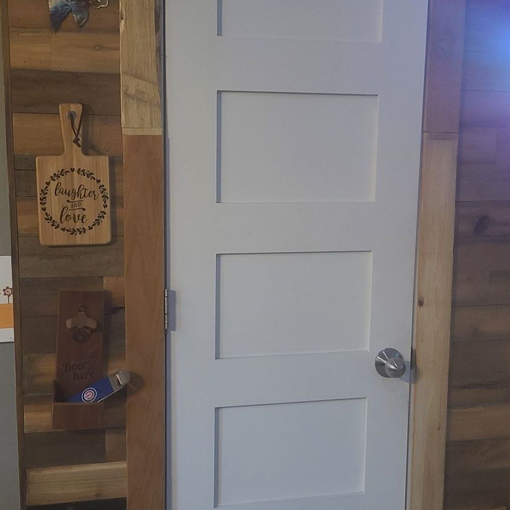 The Middle Man - a white door in a wood paneled room - General Contractors Near Me The Middle Man - a white door in a wood paneled room - General Contractors Near Me