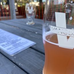 a glass of beer on a picnic table