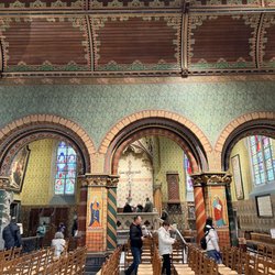 Basiliek van het Heilig Bloed - View towards the altar containing the relic of the blood of Christ.  Overseen by a priest.