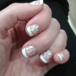 Beautiful french nail polish with free hand flowers. Beautiful french nail polish with free hand flowers.