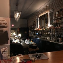 a bar with a lot of bottles on the counter