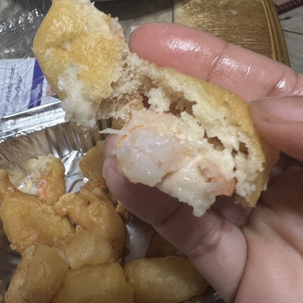Jin House - a person holding a half eaten sandwich - Chinese Near Me - Williamstown, New Jersey