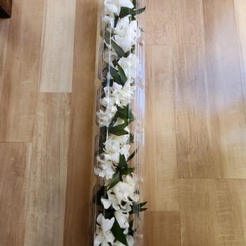 Island Leis & Bouquets - Ti leaf maile with white orchids in plastic container - Florists Near Me - Carson, California Island Leis & Bouquets - Ti leaf maile with white orchids in plastic container - Florists Near Me - Carson, California