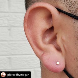 Lucky Seven Tattoo Studio - Megan Bradley lobe piercing gold disc jewelry