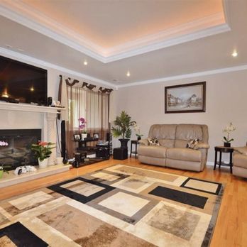 Bebe Construction - a living room with a fireplace - General Contractors Near Me
