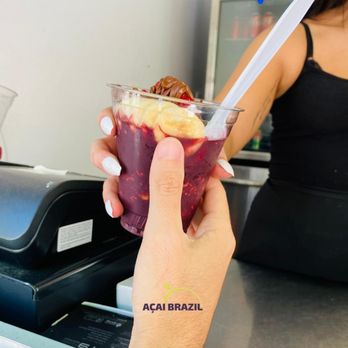 Açaí Brazil - a hand holding a cup of fruit smoothie - Acai Bowls Near Me - Orlando, Florida Açaí Brazil - a hand holding a cup of fruit smoothie - Acai Bowls Near Me - Orlando, Florida