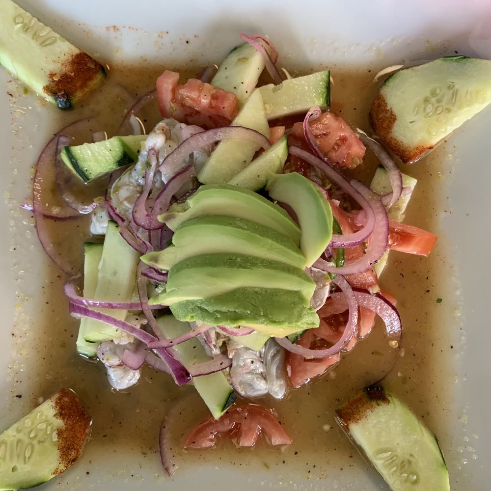Agua Chile shrimp with avocado, onions, tomatoes, cucumber dipped in Tajin, in a delicious spicy lime bath. Agua Chile shrimp with avocado, onions, tomatoes, cucumber dipped in Tajin, in a delicious spicy lime bath.