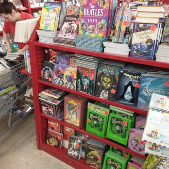 Ollie's Bargain Outlet - The employee is filling the cart with excess comics. - Discount Store Near Me - Jacksonville, Florida Ollie's Bargain Outlet - The employee is filling the cart with excess comics. - Discount Store Near Me - Jacksonville, Florida