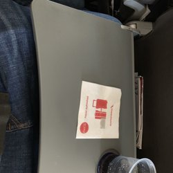 American Airlines - The table is constantly slanted because there is not enough space.