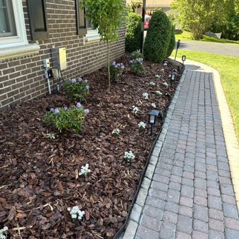 Miranda Landscaping - the front of a brick house - Landscaping Near Me