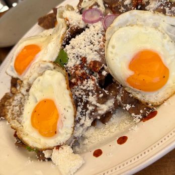 Manuela - Black Beans Chilaquiles, Crema, Fried Egg, Radish, Cilantro - New American Near Me - Los Angeles, California Manuela - Black Beans Chilaquiles, Crema, Fried Egg, Radish, Cilantro - New American Near Me - Los Angeles, California