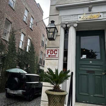 Lowland Tavern - Outside of restaurant, small waiting area in the front and cobblestone streets on the side street. - New American Near Me - Charleston, South Carolina