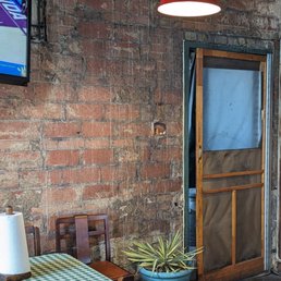 ows a table and chairs in front of a brick wall ows a table and chairs in front of a brick wall