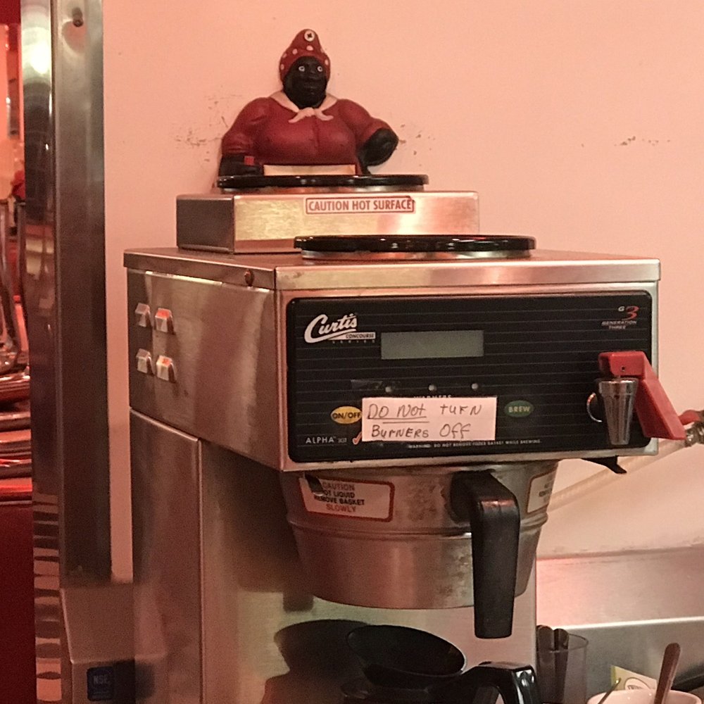 I-70 Diner - Wider view of the coffee pot where the mammy decor is located. - Diners Near Me - Flagler, Colorado I-70 Diner - Wider view of the coffee pot where the mammy decor is located. - Diners Near Me - Flagler, Colorado
