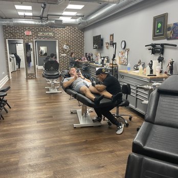 Red Octopus Tattoos - My husband scrolling while getting ink. - Piercing Near Me - Annapolis, Maryland Red Octopus Tattoos - My husband scrolling while getting ink. - Piercing Near Me - Annapolis, Maryland