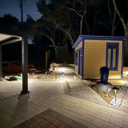 Quinones Landscaping - nightime lighting illuminates the rock-lined pathways