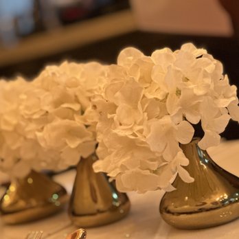 Sugar'd - white flowers in gold vases on a table - Caribbean Near Me - Brooklyn, New York