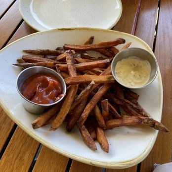 Monkeypod Kitchen by Merriman - Home made fries and home made condiments. They looked overdone but were shockingly PERFECT in every way. 10/10 - New American Near Me - Kihei, Hawaii