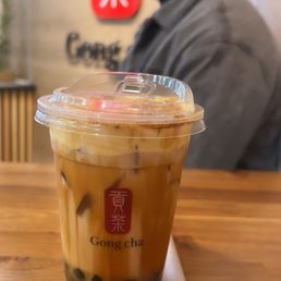 a man sitting at a table with a cup of coffee