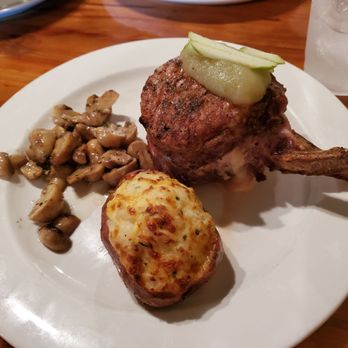 Cypress Grille - Stuffed pork chop, twice baked potato and sautéed mushrooms - New American Near Me - Boerne, Texas