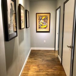 Kyung Hee Acupuncture & Herbs - Hallway entrance to our treatment rooms filled with beautiful paintings.