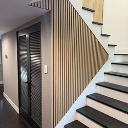HandyGleb - Wood slat accent wall fitted to the staircase profile, adding warmth and texture with clean, precise edges.