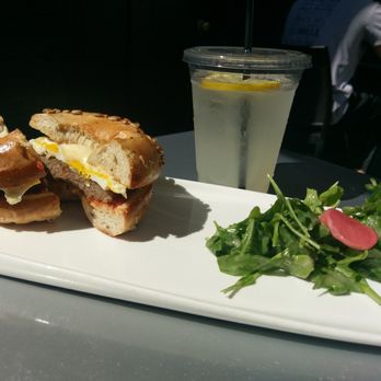 Proper Bagel - new yorker breakfast bagel (with local sage sausage on sunflower wheat bagel) and micro green salad + house lemonade - Bagels Near Me - Nashville, Tennessee Proper Bagel - new yorker breakfast bagel (with local sage sausage on sunflower wheat bagel) and micro green salad + house lemonade - Bagels Near Me - Nashville, Tennessee