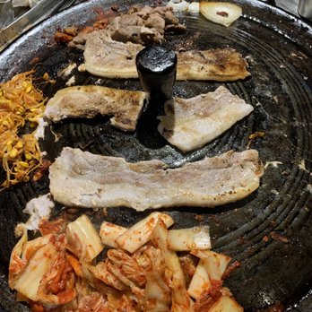 Honey Pig - a variety of food on a grill - Korean Near Me - Duluth, Georgia