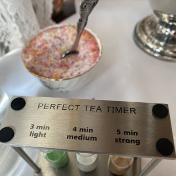 Queen Mary Tea Emporium - a silver teapot with a spoon in it - Tea Rooms Near Me - Seattle, Washington