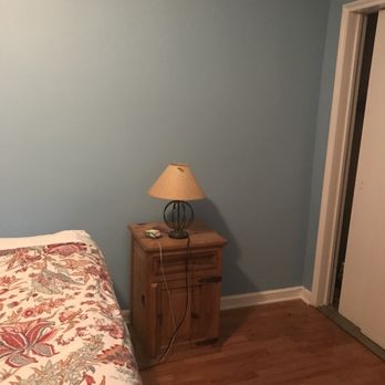 Smart Painting - a bedroom with a bed and a lamp - Painters Near Me