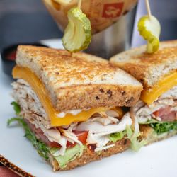 Redstone American Grill - Rotisserie Turkey Sandwich | sliced turkey breast, basil mayo, sliced cheddar, lettuce, tomato