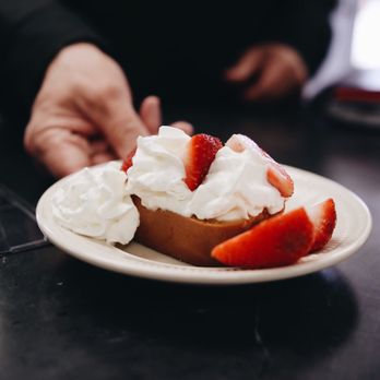 Coffee Tree - a plate of strawberries and whipped cream - Coffee & Tea Near Me - Storm Lake, Iowa