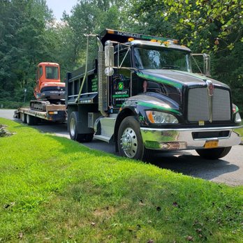 Northeast Environmental II - a tow truck towing a bulldozer - Dumpster Rental Near Me - Mamaroneck, New York Northeast Environmental II - a tow truck towing a bulldozer - Dumpster Rental Near Me - Mamaroneck, New York
