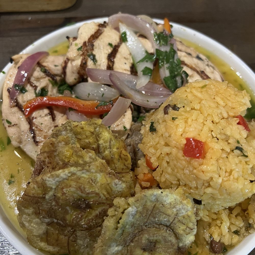 La Marginal - Chicken Breast drenched in garlic sauce, Tostones, and rice. - Puerto Rican Near Me - San Antonio, Texas La Marginal - Chicken Breast drenched in garlic sauce, Tostones, and rice. - Puerto Rican Near Me - San Antonio, Texas