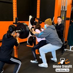 Gimme Fit - Personal Trainer Coach Felipe helping members assess strength